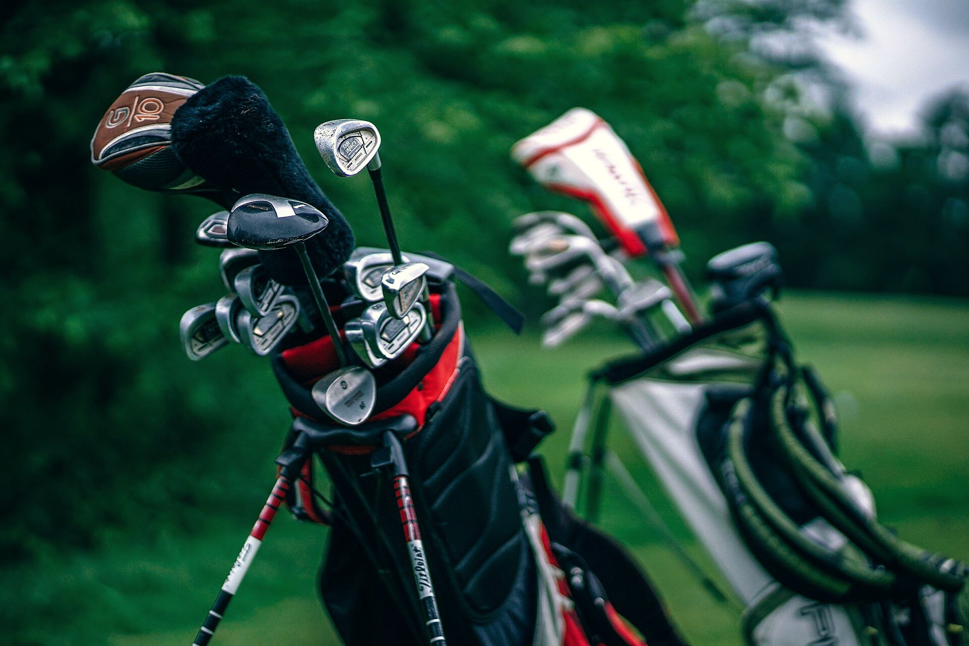 Golf bags beside a green fairway