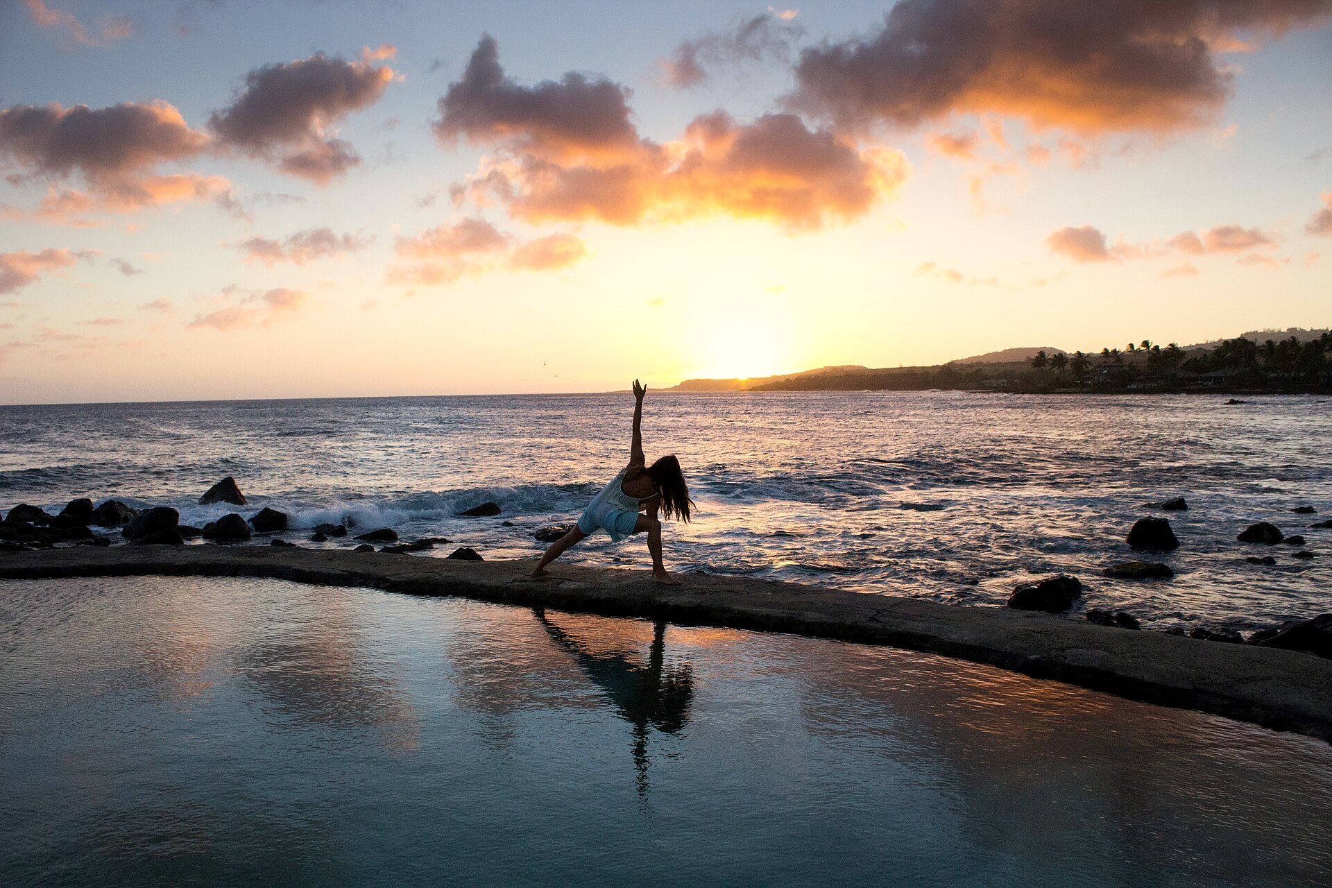 Yoga practice by the sea at sunrise